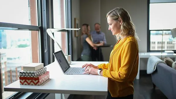 a woman working on her laptop in a happy mood